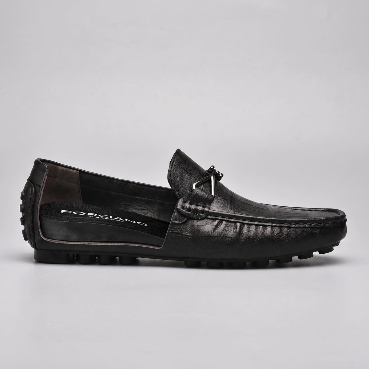Side cutaway view of a black leather FORCIANO HERITAGE Elevator Loafer revealing the branded internal lift structure, metal accent and studded outsole.