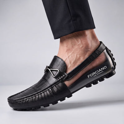 Close-up of a black leather FORCIANO HERITAGE Elevator Loafer worn on foot, revealing the branded internal lift and textured rubber sole.