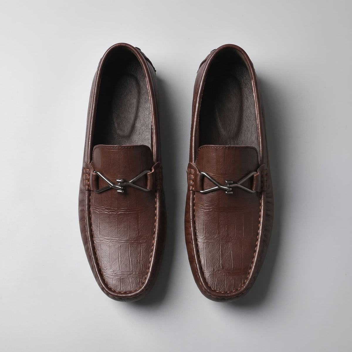 Overhead view of brown leather FORCIANO HERITAGE Elevator Loafers showing both shoes, textured leather uppers, stitched toe edges and metal hardware.
