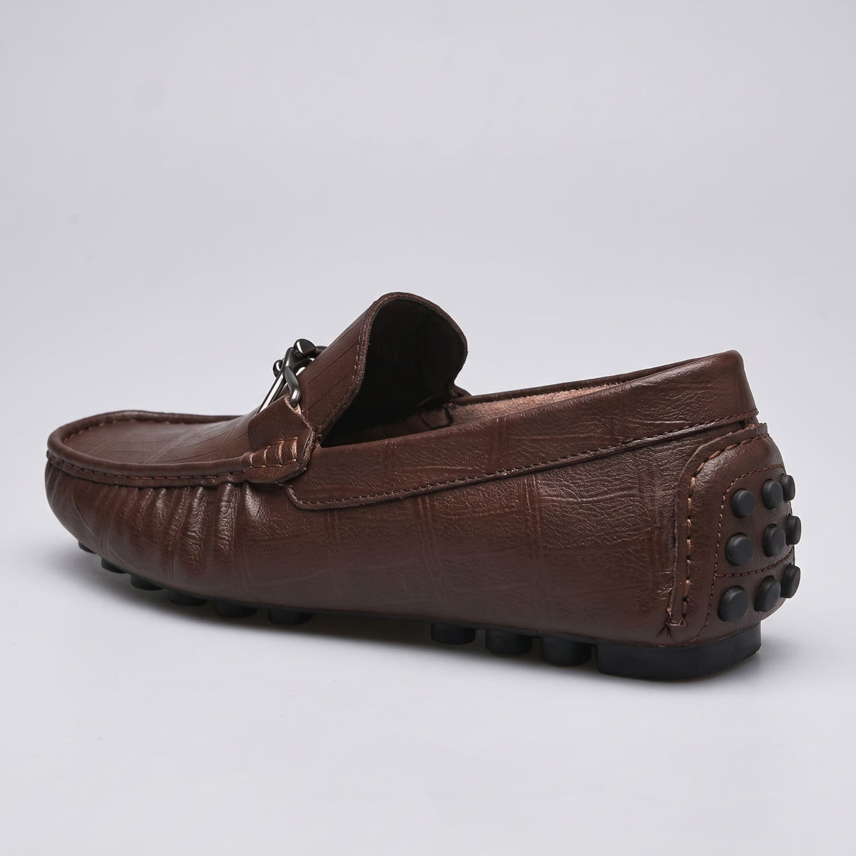Brown FORCIANO HERITAGE Elevator Loafer in leather, viewed from the rear three-quarter angle with visible heel stitching and black rubber studs.