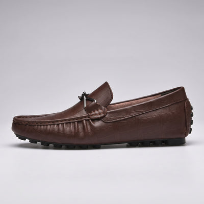 FORCIANO HERITAGE Elevator Loafers in brown leather, single shoe side profile showing the metal accent, stitched moccasin toe and black rubber studs.