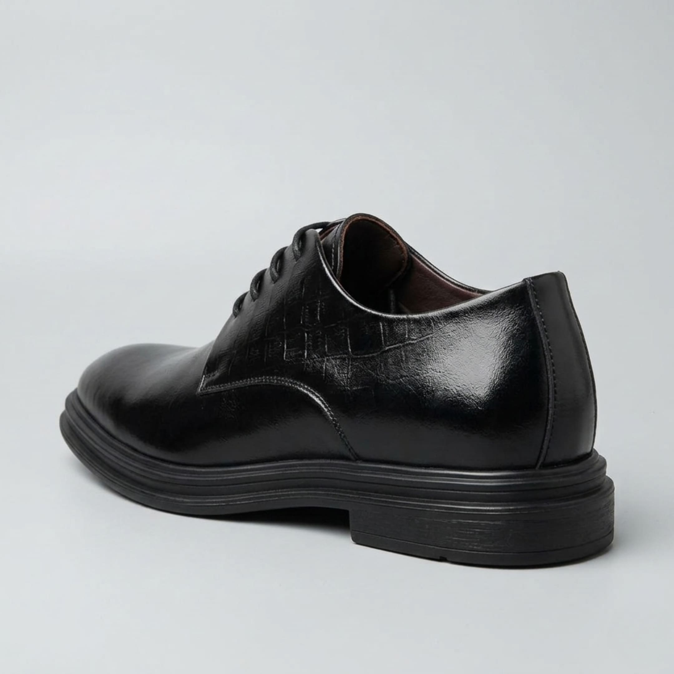 FORCIANO IMPERIAL black premium leather dress shoe in a rear three-quarter view highlighting the heel and layered black sole.