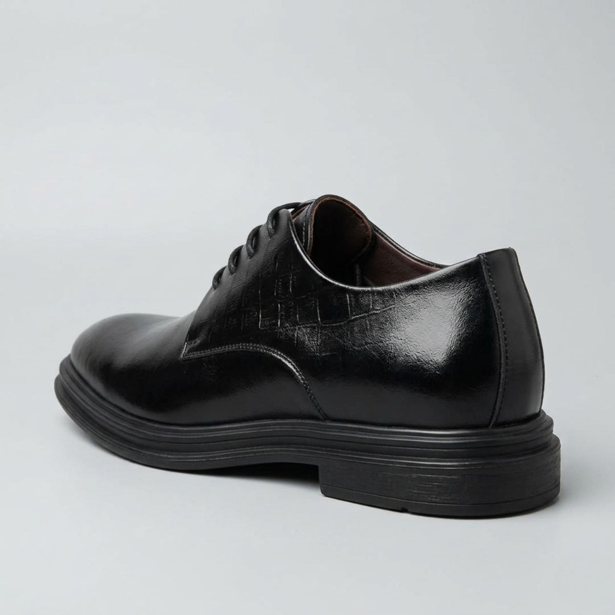 FORCIANO IMPERIAL black premium leather dress shoes that make you taller in a rear three-quarter view highlighting the heel and layered black sole.