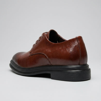 FORCIANO IMPERIAL brown premium leather dress shoe shown from a rear three-quarter angle with the black heel and sole visible.