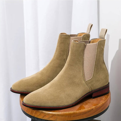 FORCIANO IVORY beige suede elevator Chelsea boots displayed as a pair on a wooden stool.