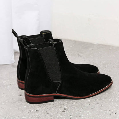 FORCIANO IVORY black suede elevator boots shown as a pair from a rear-side angle with elastic panels.