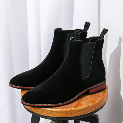 FORCIANO IVORY black suede elevator Chelsea boots displayed as a pair on a wooden stool.