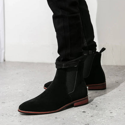 FORCIANO IVORY black suede height increasing boots worn from a front-side angle with elastic side panels.