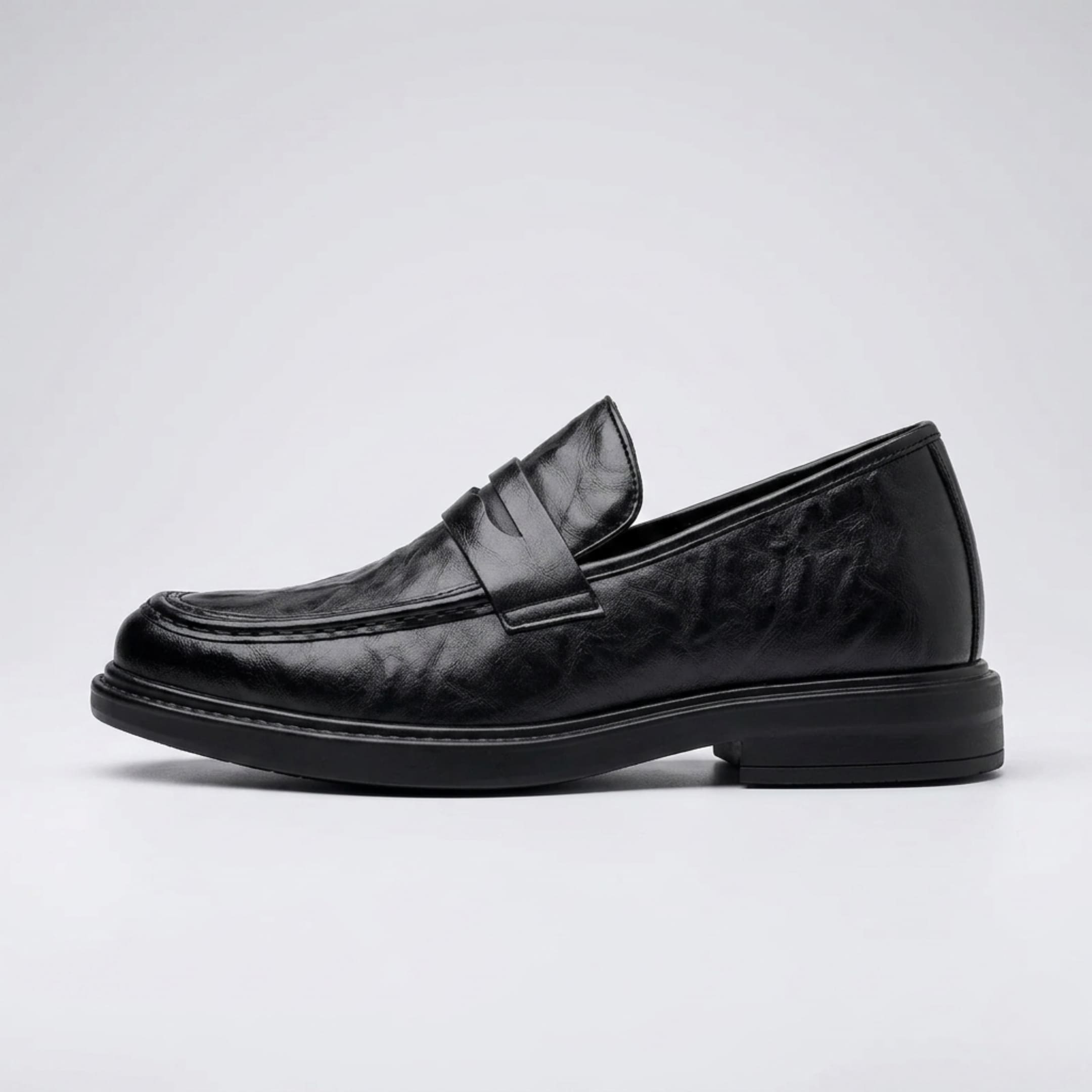 FORCIANO KINGSLEY black leather height increasing loafer shown in a clean side profile, highlighting the penny strap and slip-on design.