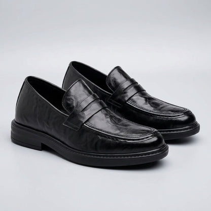 FORCIANO KINGSLEY black leather height increasing loafers shown as a pair from a front three-quarter angle with classic penny straps.