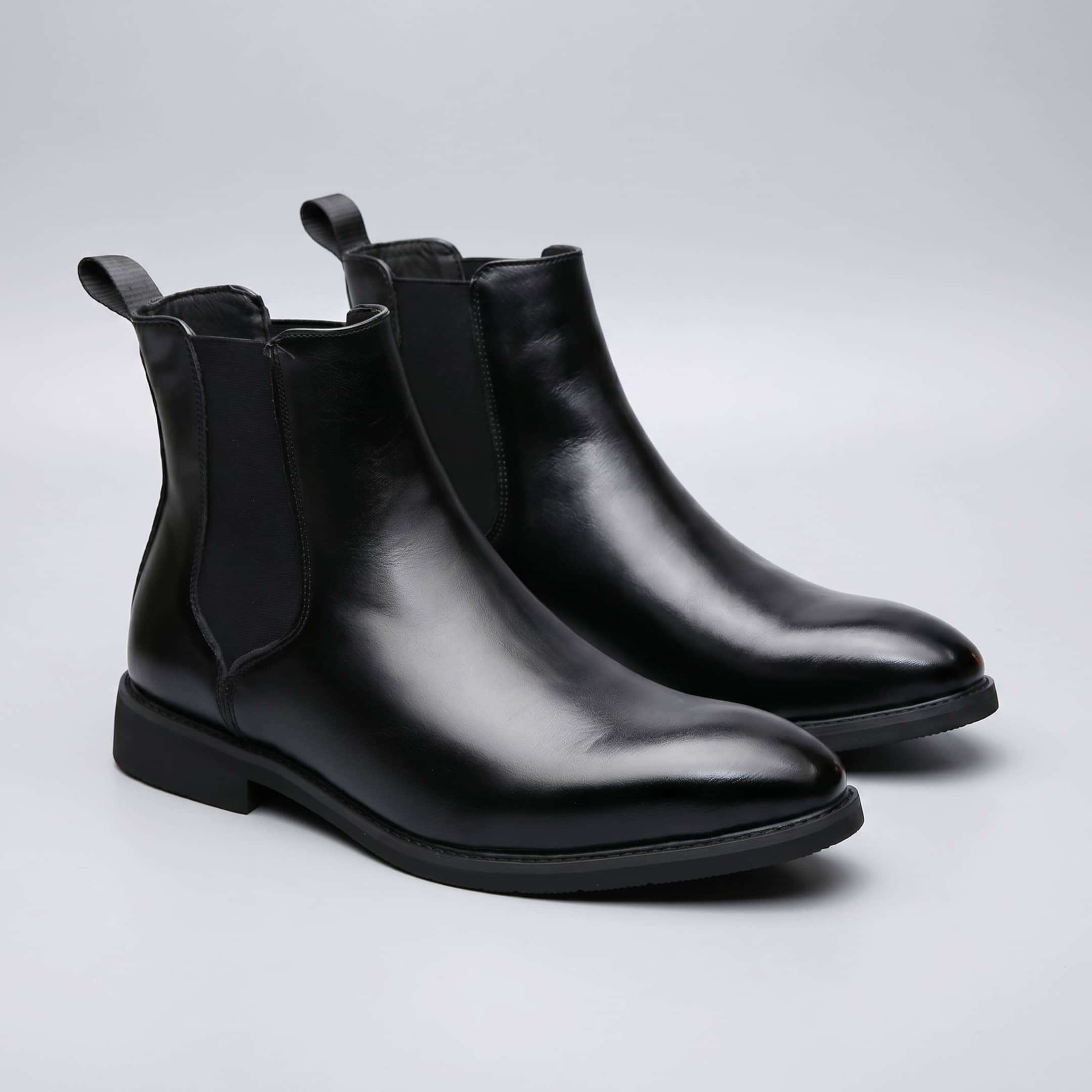 FORCIANO LUXOR black leather height increasing boots shown as a pair in an angled studio view.
