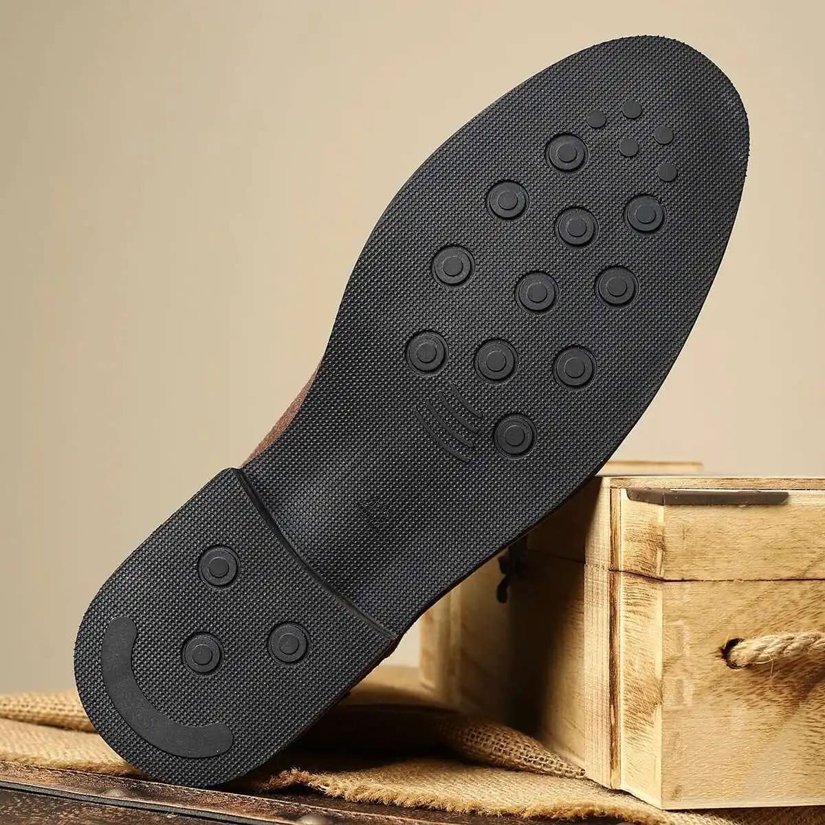 Black outsole view of FORCIANO MERIDIAN elevator boots, showing the textured tread and circular traction pattern.