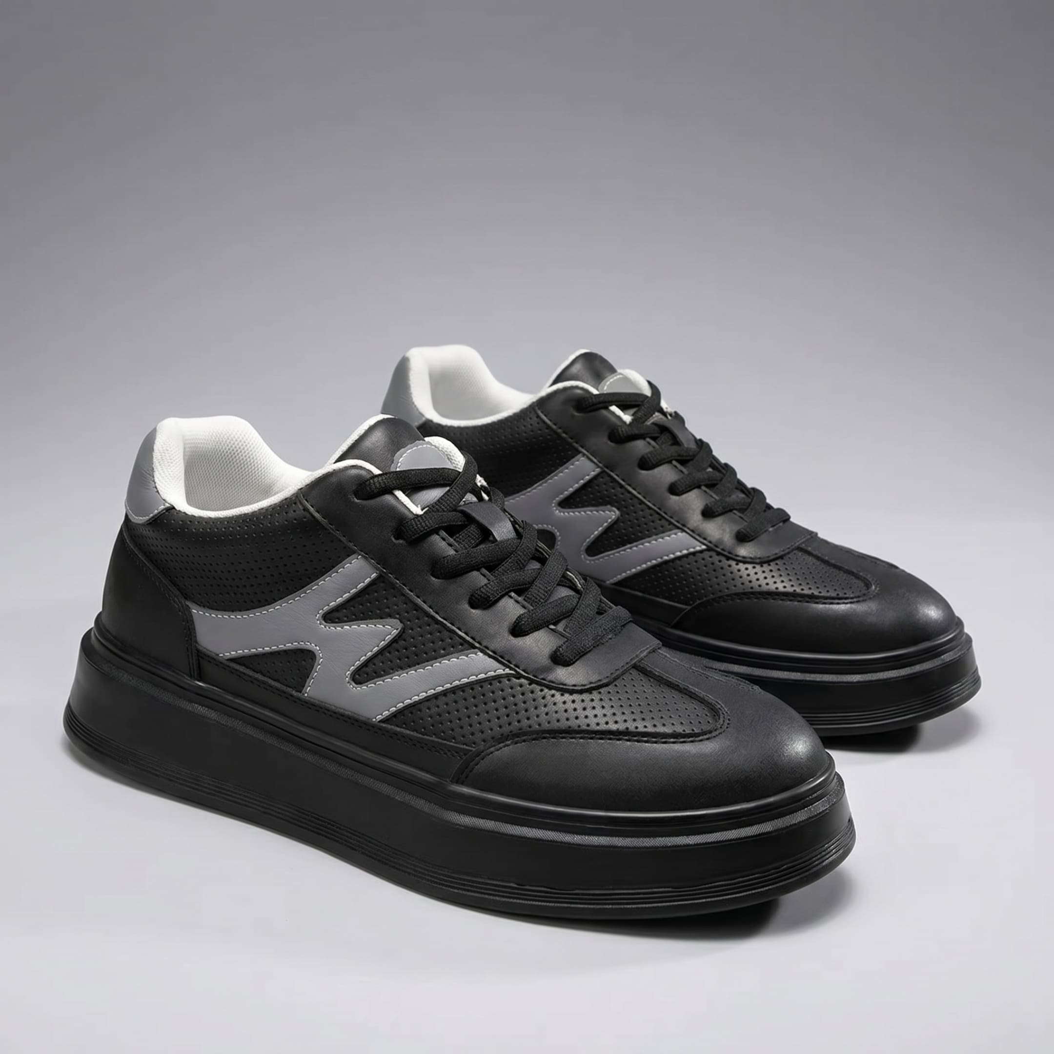 FORCIANO MILANO black elevator sneakers shown as a pair from a front three-quarter angle with leather upper and gray side detailing.