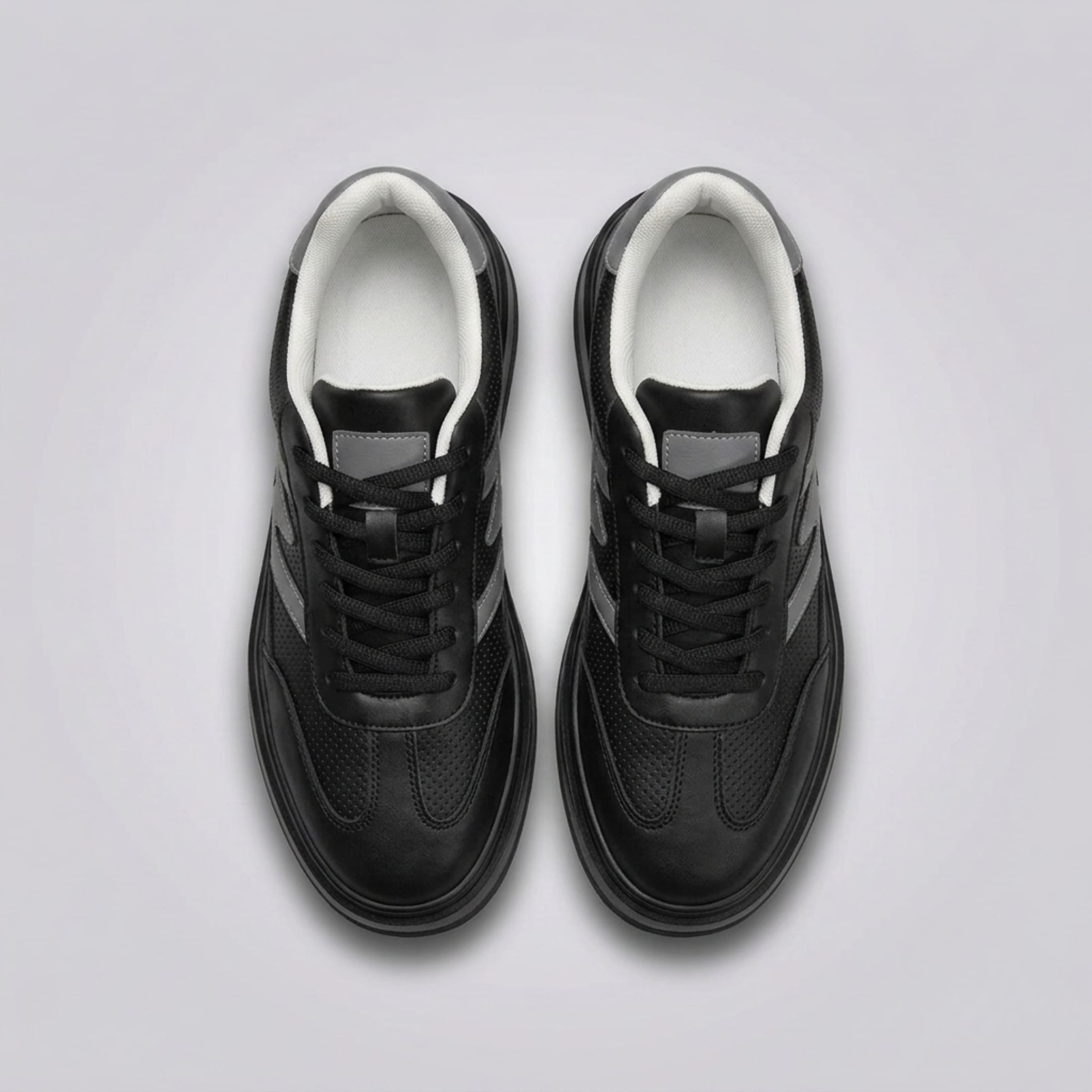 FORCIANO MILANO black elevator sneakers shown as a pair from above with black laces, leather upper, gray accents and white inner lining.