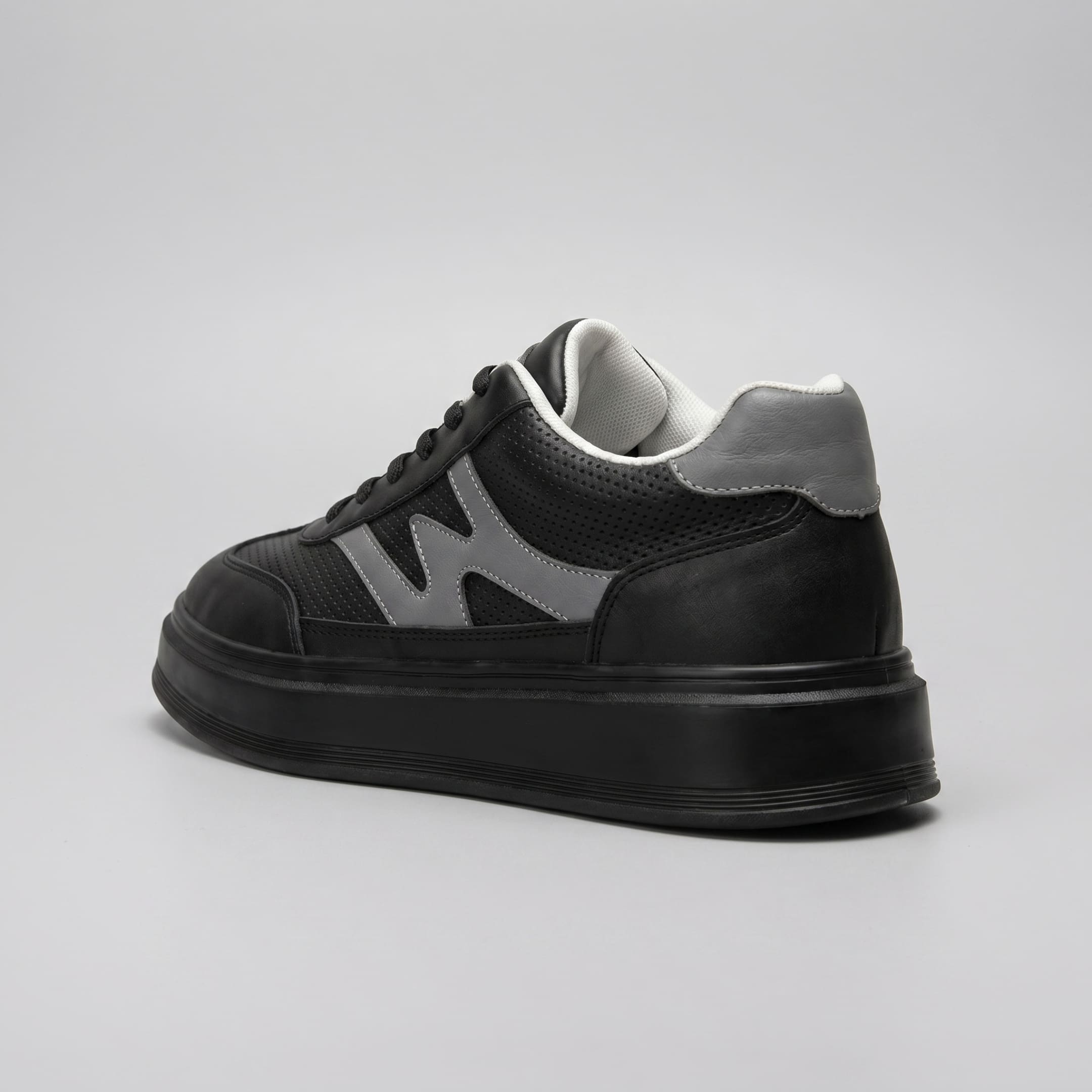 FORCIANO MILANO black height boosting sneakers shown from the rear three-quarter angle with leather upper, gray heel accent and black raised sole.