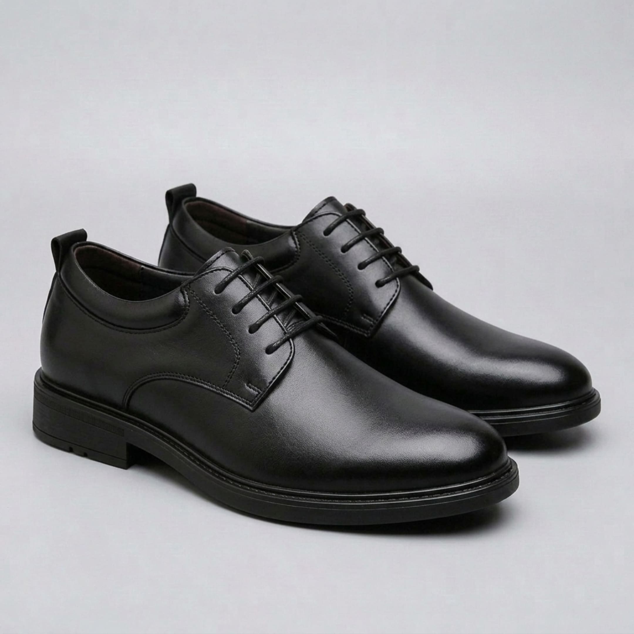 FORCIANO MOMENTUM black height increasing dress shoes shown as a pair from a polished front three-quarter angle.