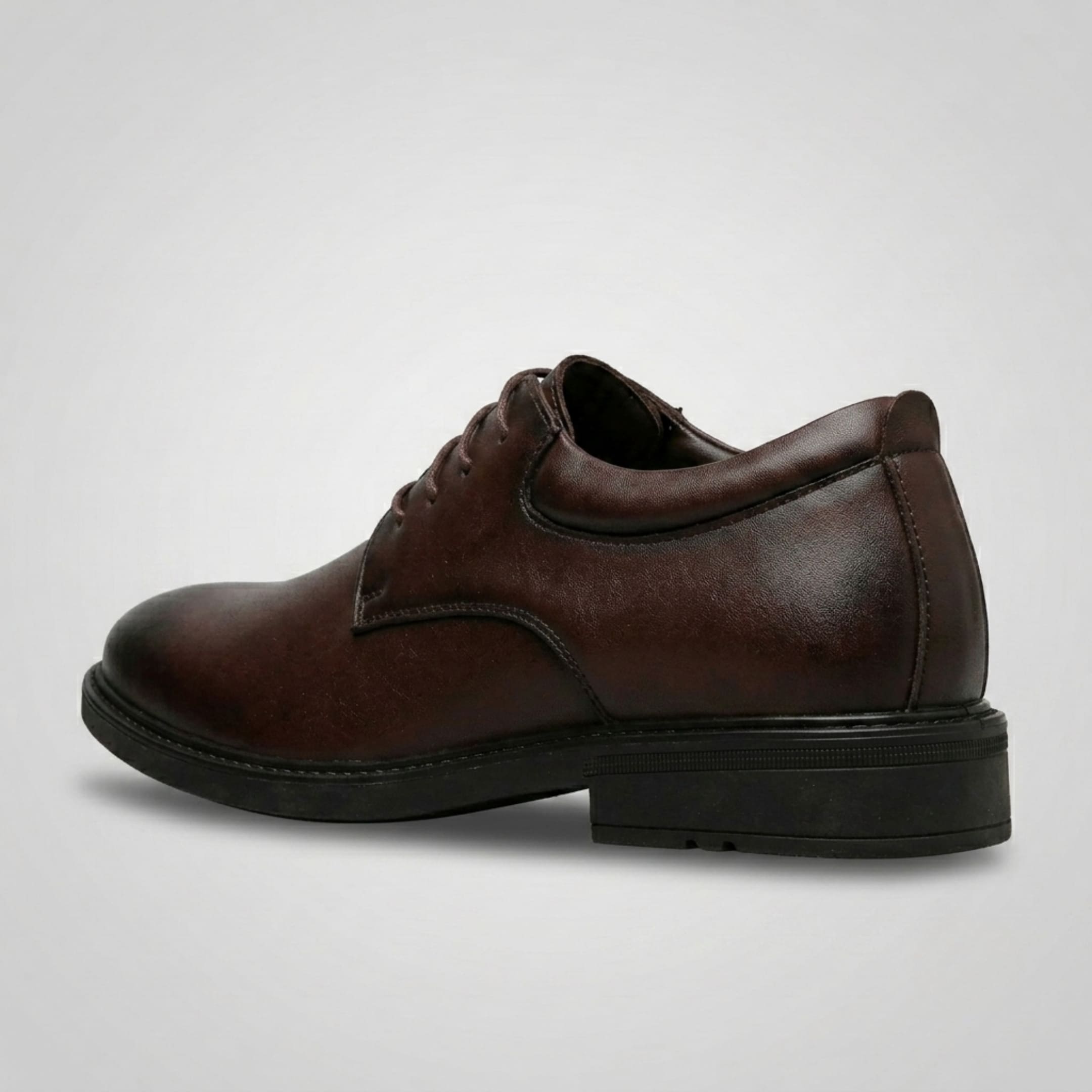 FORCIANO MOMENTUM brown elevator dress shoe shown from the rear-side angle, highlighting the heel and formal profile.