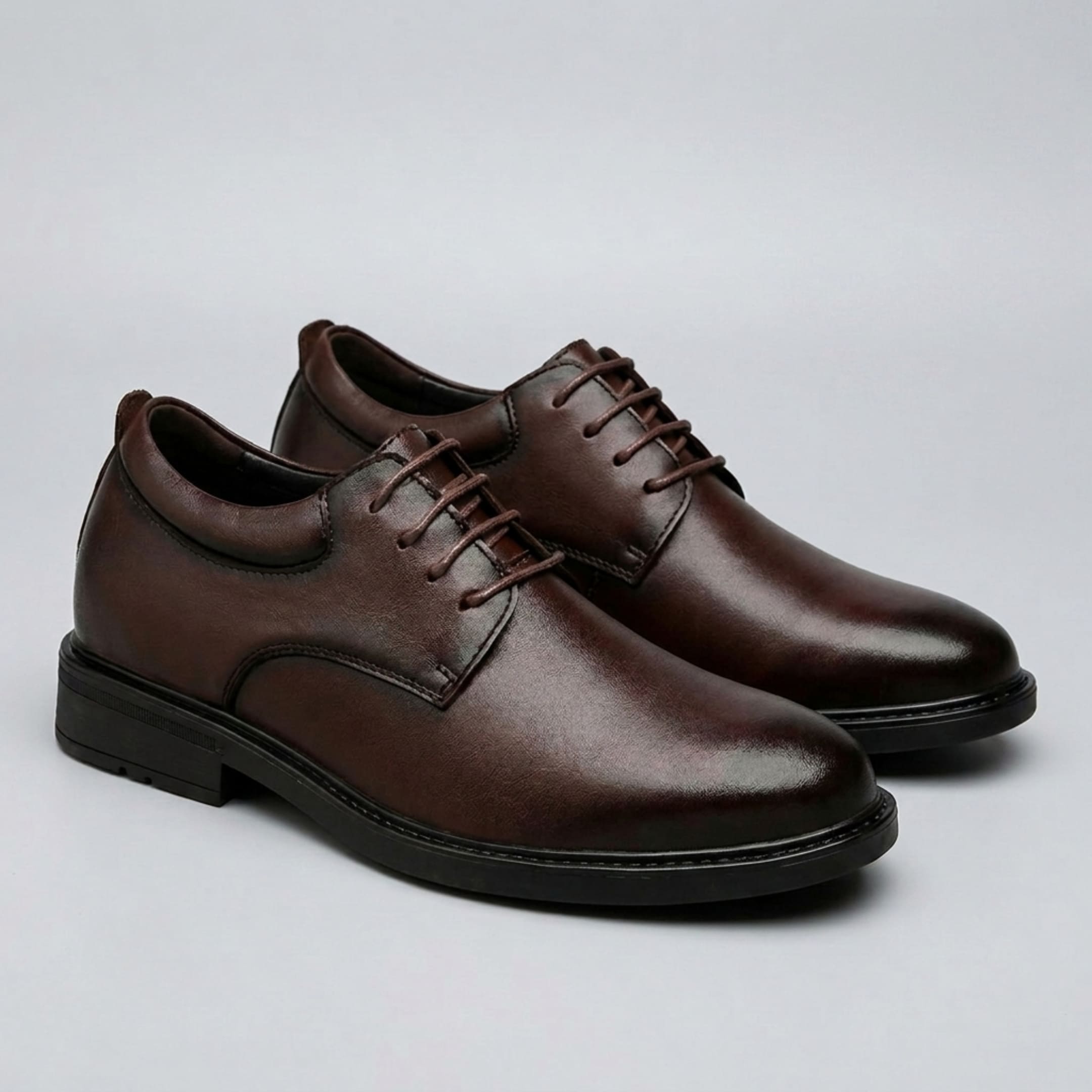 FORCIANO MOMENTUM brown height increasing dress shoes shown as a pair from a front three-quarter view.