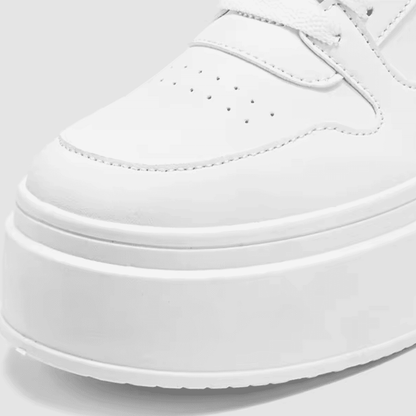 FORCIANO MONARCH white height increasing sneakers shown in a close-up detail of the perforated toe area and raised sole.