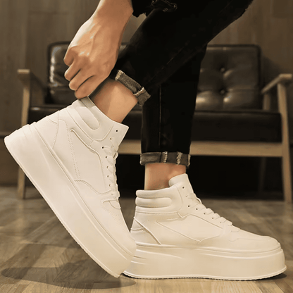 FORCIANO MONARCH white height increasing sneakers worn in a side-angle lifestyle view with one shoe raised and the high-top profile visible.