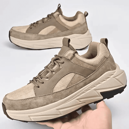 FORCIANO NORTHRIDGE beige height increasing sneakers shown as a pair, with one held in hand from a front three-quarter angle.