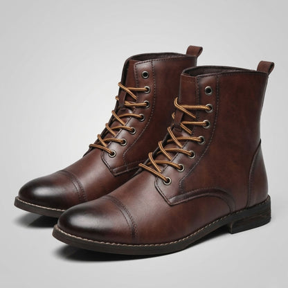 FORCIANO OUTLAW dark brown leather elevator boots shown as a lace-up pair from a front three-quarter angle, highlighting the cap toe and leather finish.