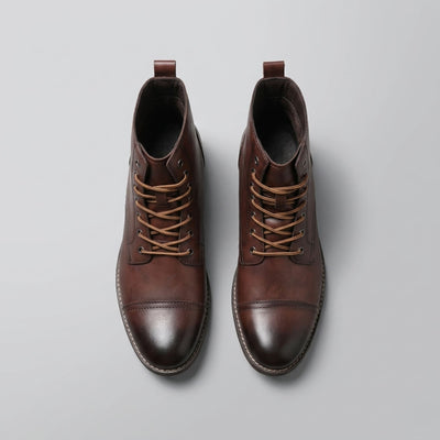 FORCIANO OUTLAW dark brown leather elevator boots shown from the top, highlighting the lace-up front, metal eyelets, and cap-toe design.