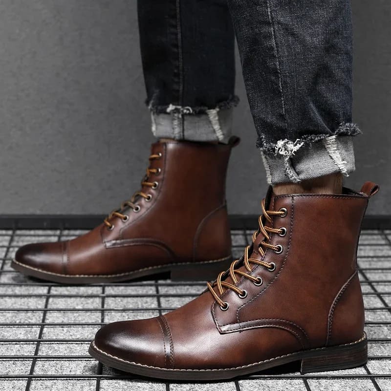 FORCIANO OUTLAW dark brown leather elevator boots worn with rolled jeans, shown from the side in a casual lifestyle setting.