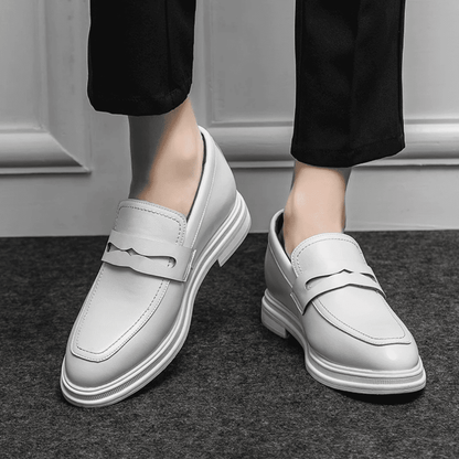 FORCIANO PANTHERA white leather elevator loafers worn with black trousers in a front lifestyle view showing the pair and loafer straps.