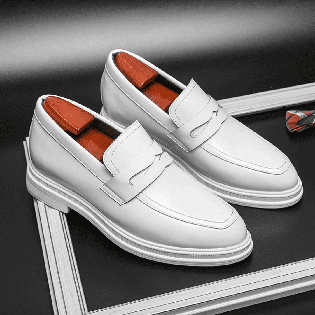 FORCIANO PANTHERA white leather elevator loafers shown as a pair from a front three-quarter angle on a framed dark display.