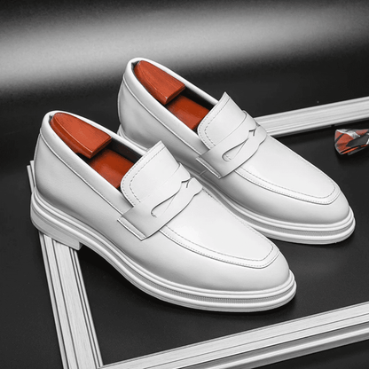 FORCIANO PANTHERA white leather elevator loafers shown as a pair from a front three-quarter angle on a framed dark display.