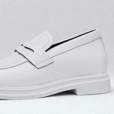 FORCIANO PANTHERA white leather elevator loafers shown in a close-up side detail highlighting the smooth upper, strap and white sole.