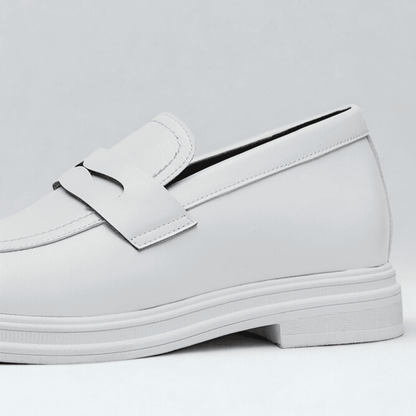 FORCIANO PANTHERA white leather elevator loafers shown in a close-up side detail highlighting the smooth upper, strap and white sole.