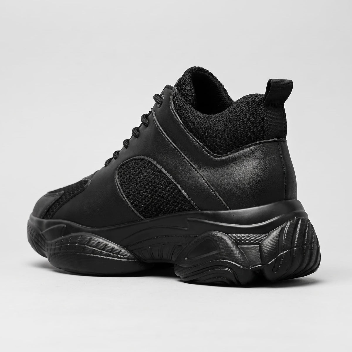 FORCIANO PEGASUS black height increasing sneakers shown from the rear three-quarter view with heel and pull tab detail.