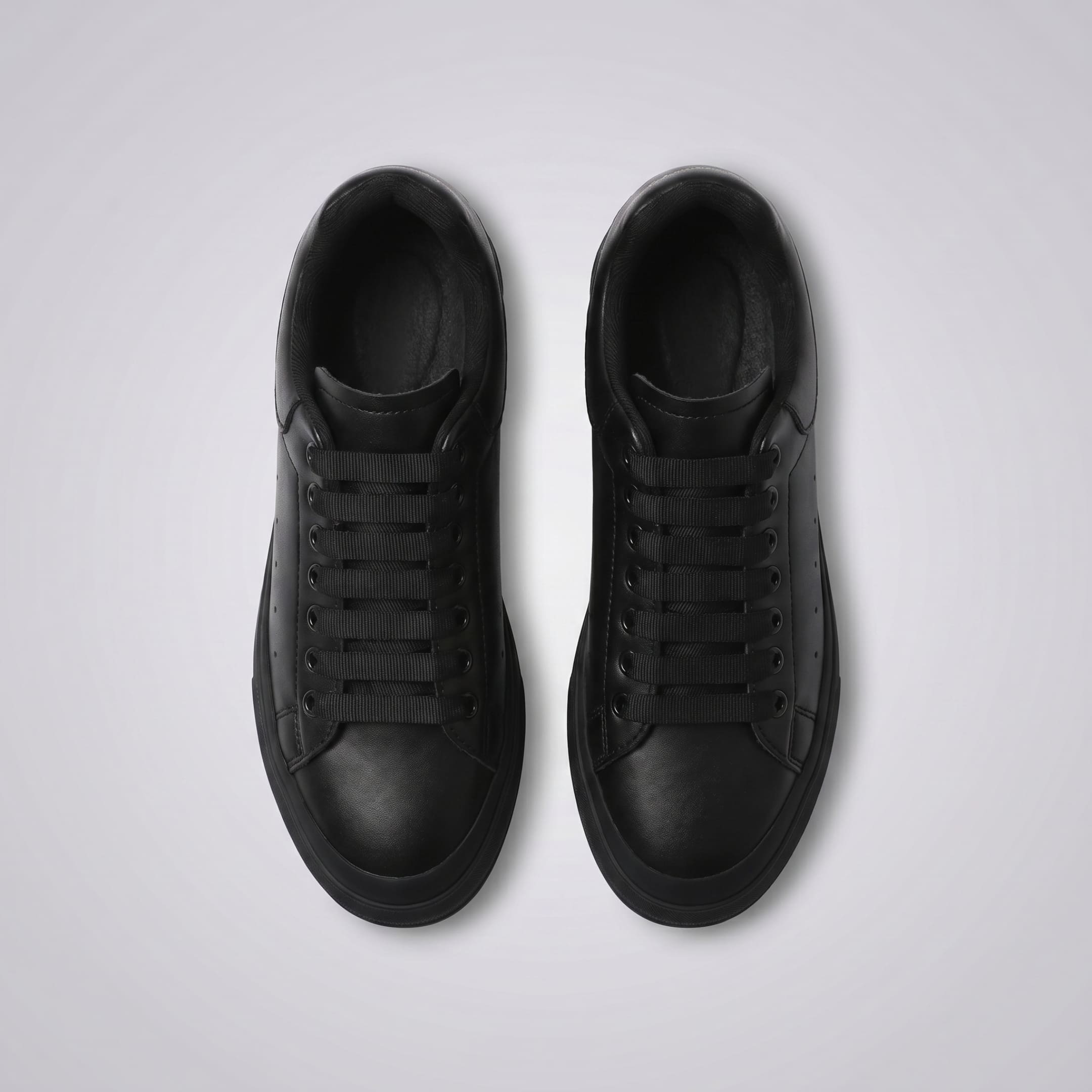 FORCIANO PORTOFINO black leather sneakers shown side by side from the top view with black laces and matching soles.