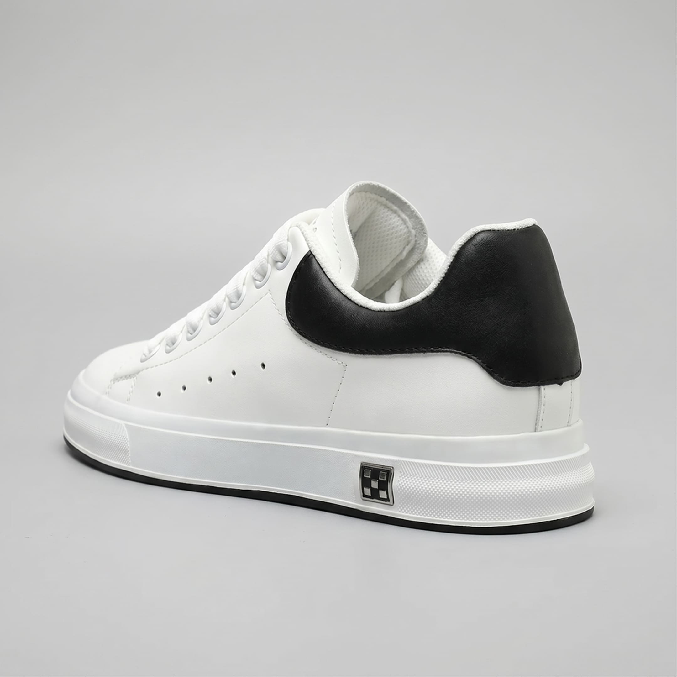 FORCIANO PORTOFINO white leather sneaker with a black heel panel, shown from a rear three-quarter angle with the raised sole profile visible.