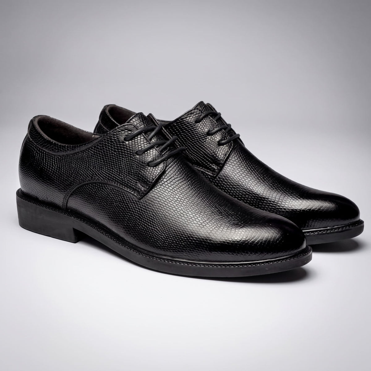Pair of black Crocodile-style FORCIANO PRESTIGE Height Increasing Shoes shown from a front three-quarter angle.