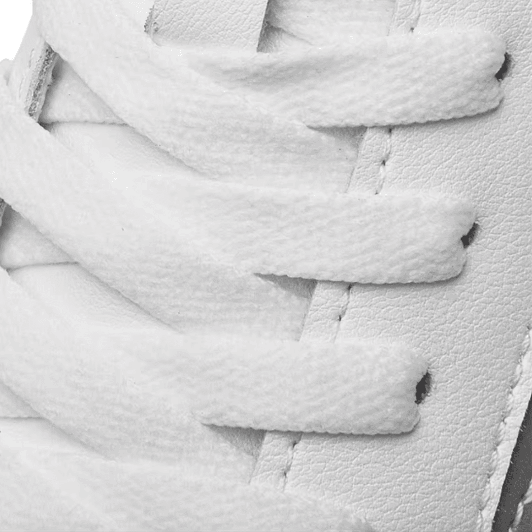 Close-up of white laces and textured upper detailing on FORCIANO PRIME white height increasing sneakers.