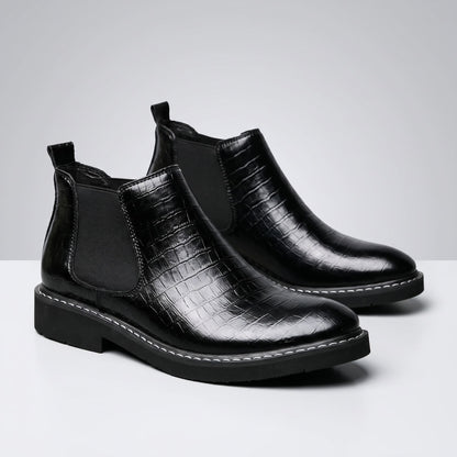 FORCIANO RAPTOR men's elevator boots in black shown as a pair from a front three-quarter angle with textured uppers and elastic side panels.
