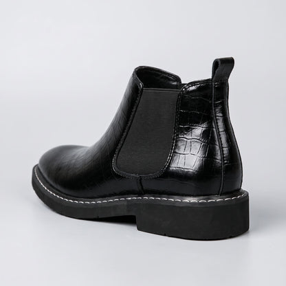 FORCIANO RAPTOR men's elevator boots in black shown from the rear three-quarter angle with elastic side panel, pull tab and raised heel profile.