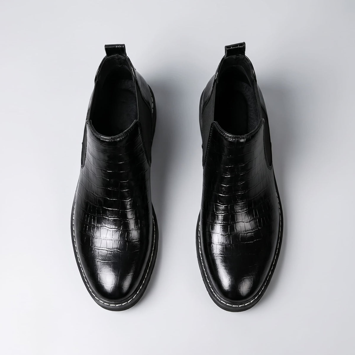 FORCIANO RAPTOR men's elevator boots in black shown as a pair from the top view, displaying the openings, textured uppers and pull tabs.