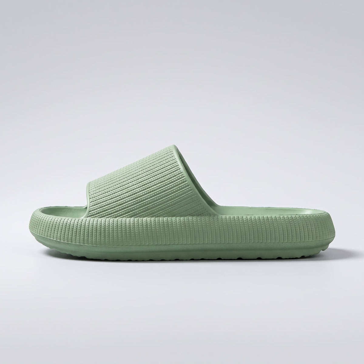 FORCIANO REESE green height increasing slippers for women shown in a full side profile with textured lightweight EVA upper and raised slide sole.