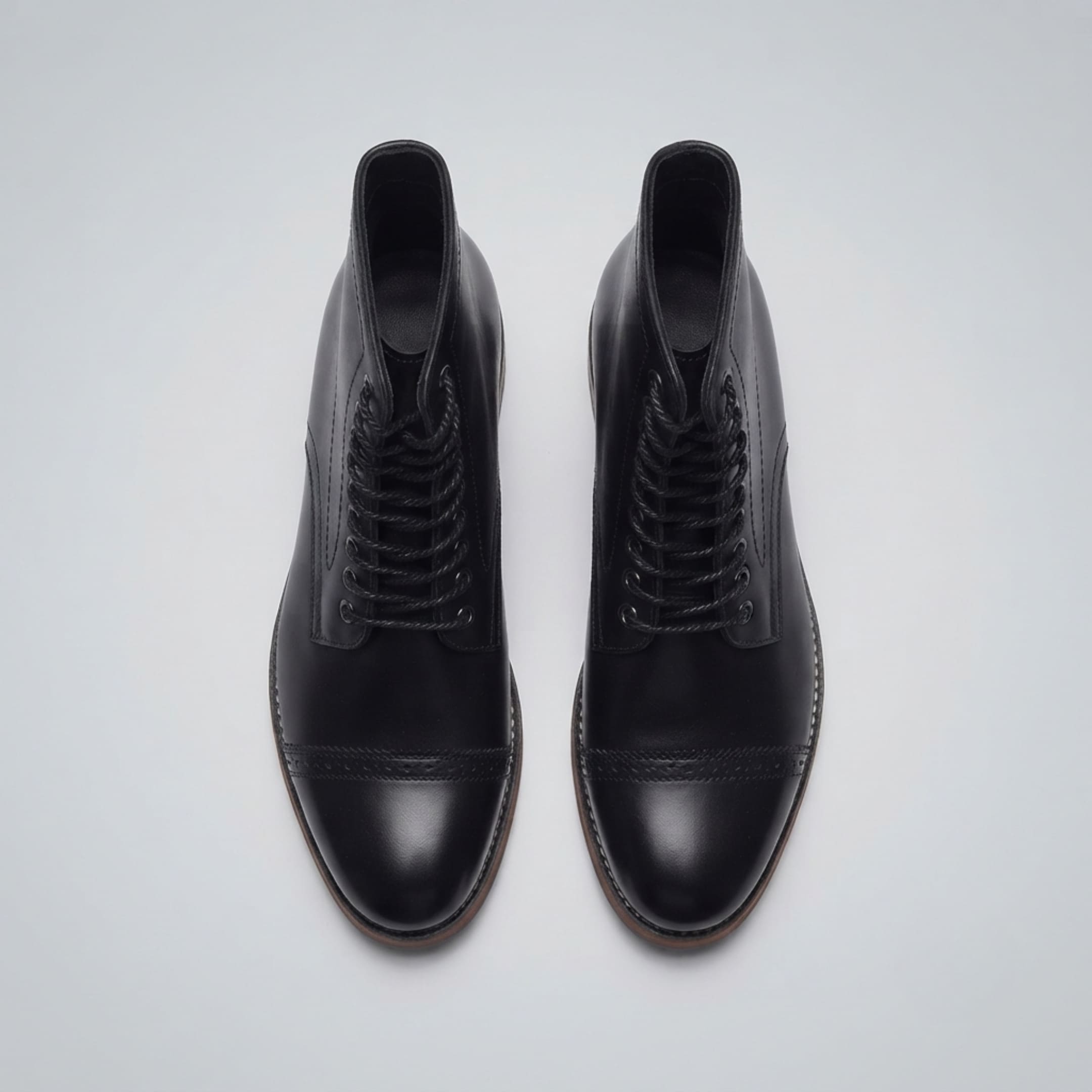 FORCIANO ROMANO black height increasing boots with genuine leather uppers shown as a pair from above with lace-up fronts and cap toes visible.