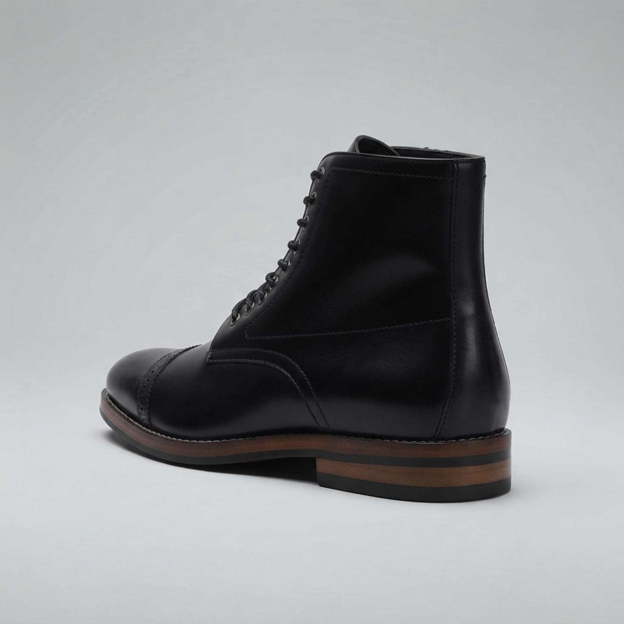 FORCIANO ROMANO black height increasing boot with genuine leather upper shown from a rear three-quarter angle, highlighting the heel and side profile.