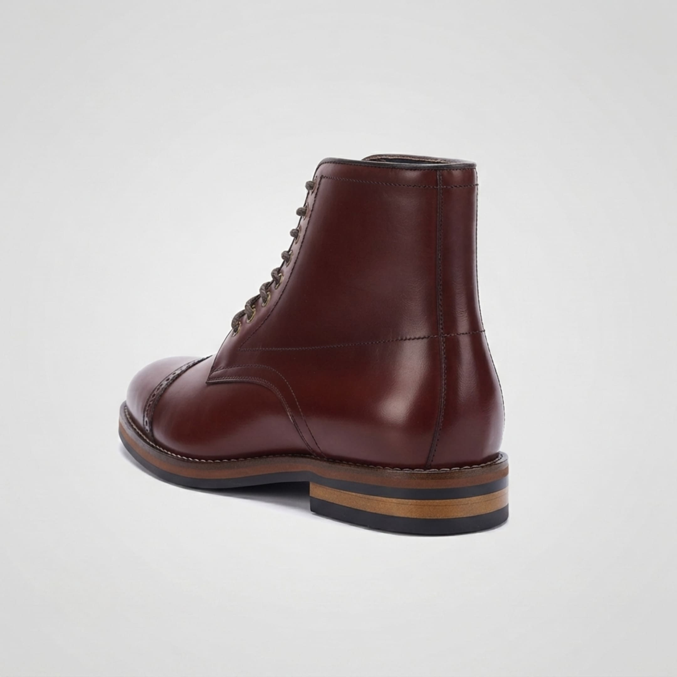 FORCIANO ROMANO brown height increasing boot with genuine leather upper shown from a rear three-quarter angle, highlighting the back seam and layered heel.