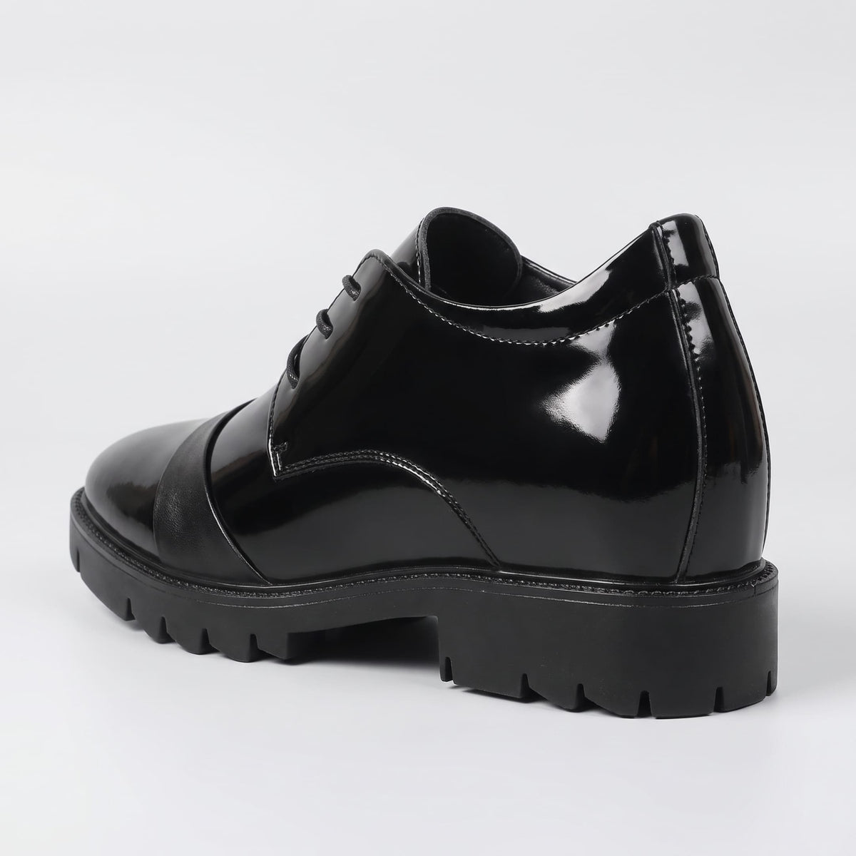 FORCIANO ROYALE black Height Increasing Shoes shown from a rear three-quarter angle with sleek leather design and thick black sole.