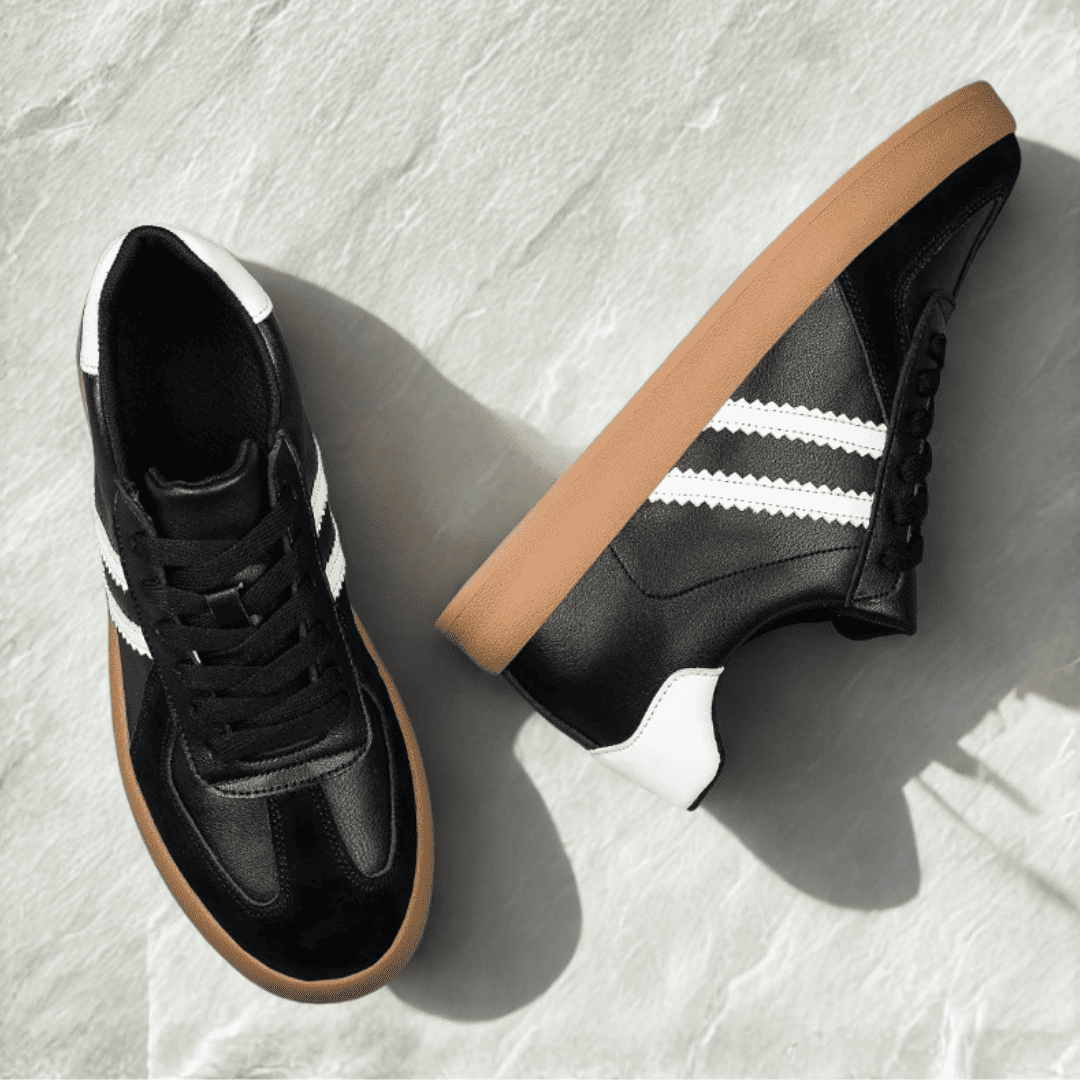 FORCIANO SABER black height increasing sneakers with white stripes, gum soles and split leather uppers arranged as a pair in an overhead view.