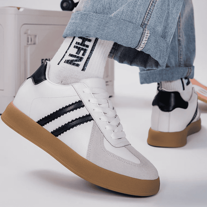 FORCIANO SABER white height increasing sneakers with black stripes and split leather uppers worn with cuffed jeans in a casual lifestyle view.