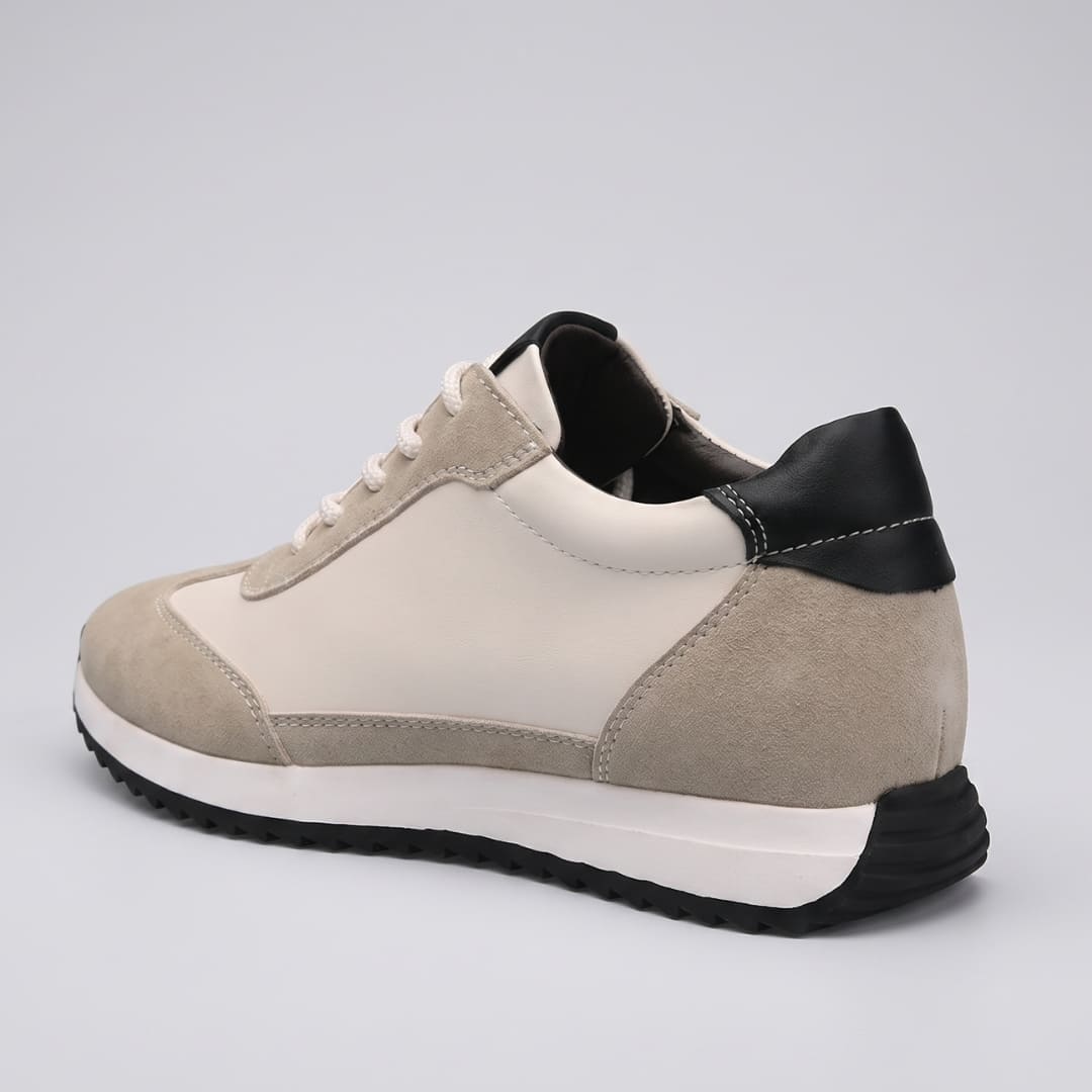 FORCIANO SALVATORE beige height increasing sneakers with cow suede upper, black heel accent and white midsole shown from the rear three-quarter angle.