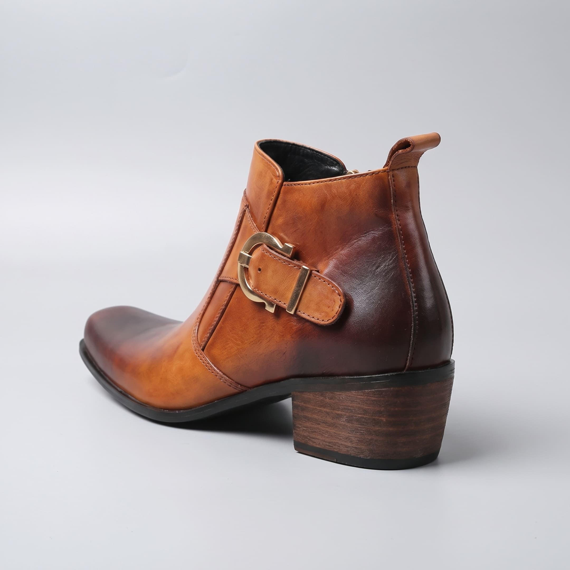 FORCIANO SCAROSSO brown genuine leather height increasing boot in rear three-quarter view showing the single buckle, back pull tab and block heel.